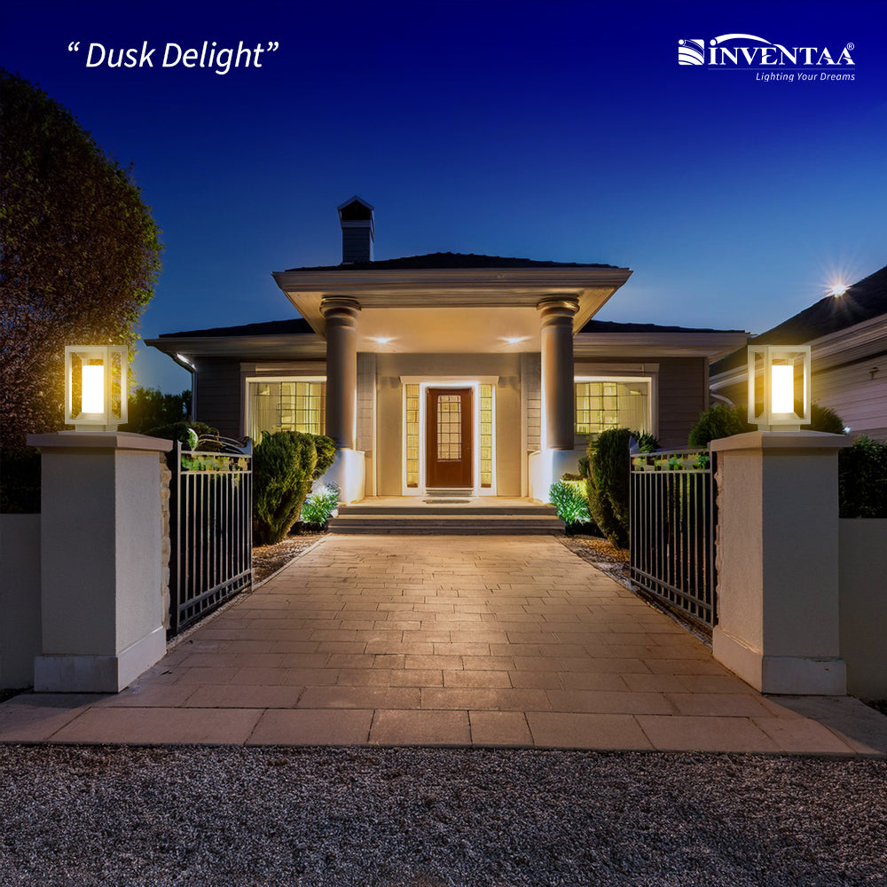Elegant gate wall light design on pillars lighting home entrance at dusk