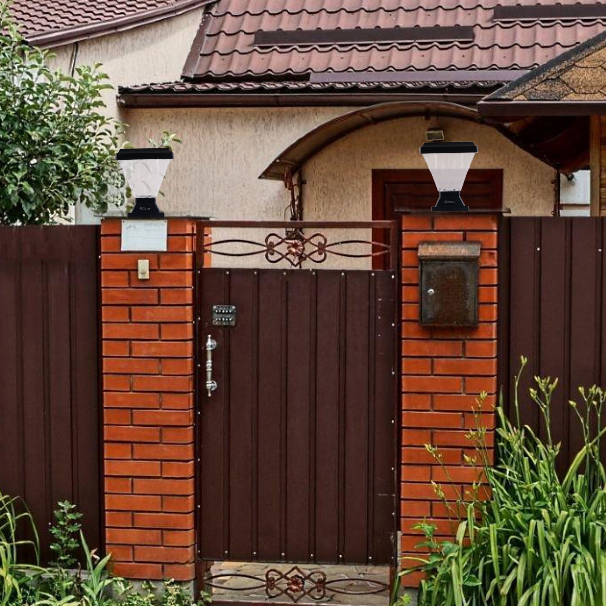 Modern black gate column lights on brick pillars illuminating the main entrance gate, enhancing home security and design.